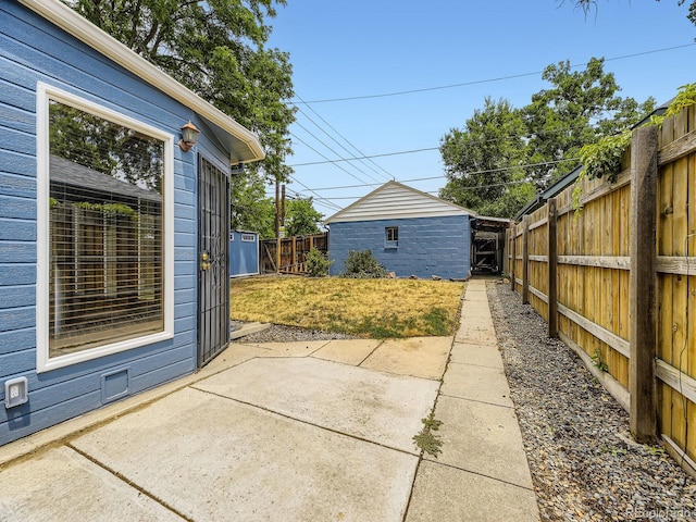 2102 S Pearl St, Denver, CO 80210 - fenced backyard with a patio and an outdoor structure