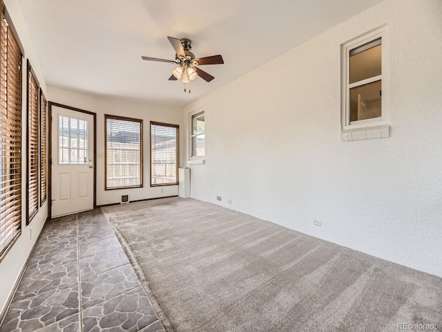 2102 S Pearl St, Denver, CO 80210 - empty room with ceiling fan and stone floors