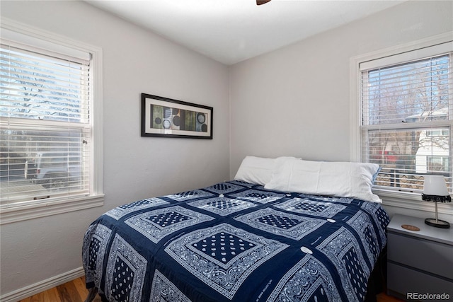 2886 S Acoma St, Englewood, CO 80110 - bedroom with baseboards, multiple windows, and wood finished floors