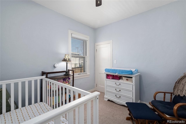 2886 S Acoma St, Englewood, CO 80110 - bedroom featuring a nursery area, baseboards, ceiling fan, and carpet