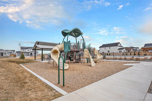 community playground with fence and a residential view