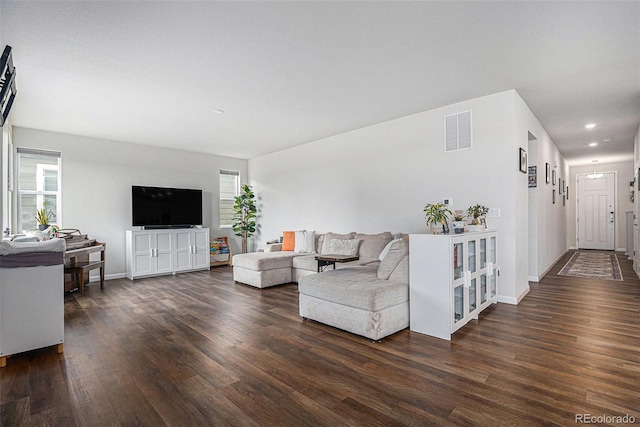 living area with recessed lighting, baseboards, visible vents, and dark wood finished floors