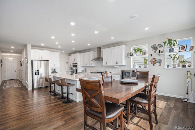 dining area with dark wood-style flooring, baseboards, and recessed lighting