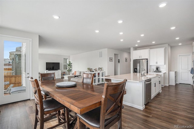 dining area with dark wood-style flooring and recessed lighting