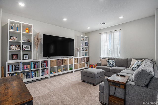 living room featuring carpet flooring, recessed lighting, a textured ceiling, and visible vents