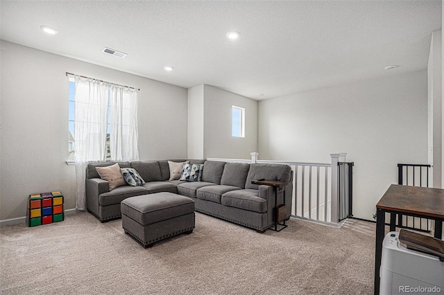 living room with carpet floors, recessed lighting, baseboards, and visible vents