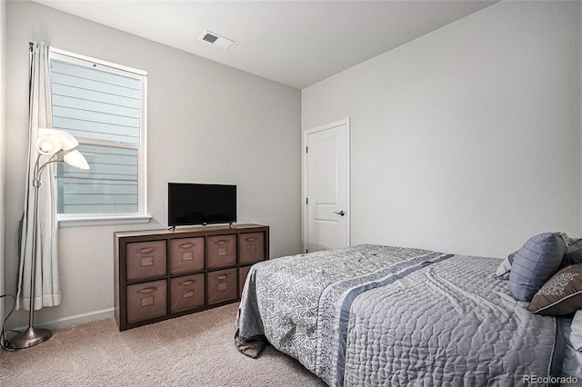 bedroom with light colored carpet, baseboards, and visible vents
