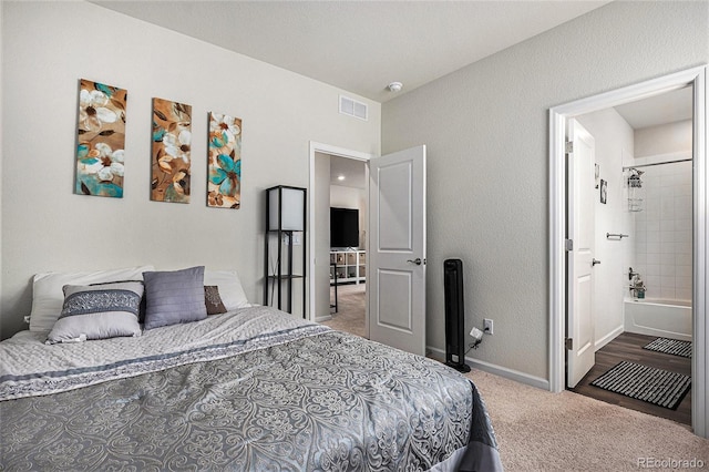 carpeted bedroom with visible vents and baseboards
