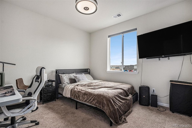 carpeted bedroom with baseboards and visible vents