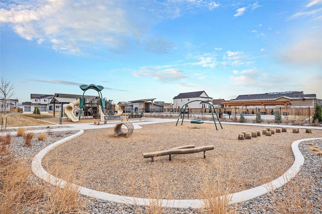 community jungle gym with fence and a residential view
