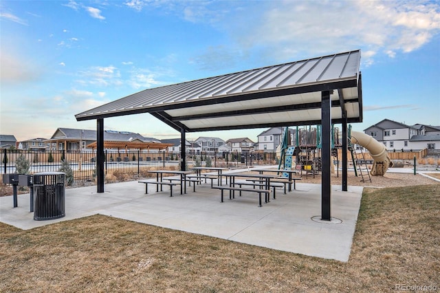 view of property's community with fence, a residential view, and playground community
