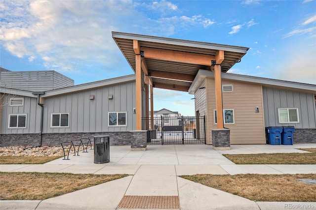 1408 Brookfield Pl, Lafayette, CO 80026 - view of property exterior with board and batten siding, a gate, fence, and a patio area