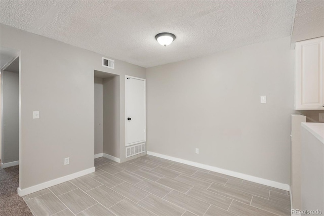 18071 E Kentucky Ave Unit 203, Aurora, CO 80017 - empty room featuring baseboards and a textured ceiling