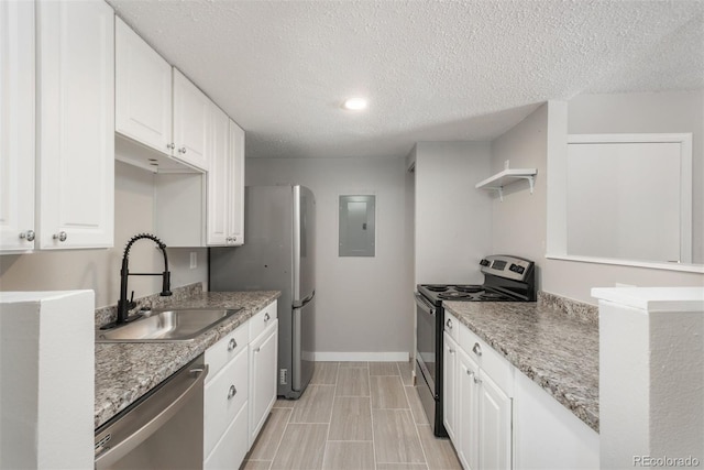 18071 E Kentucky Ave Unit 203, Aurora, CO 80017 - kitchen with stainless steel appliances, a sink, electric panel, white cabinets, and open shelves