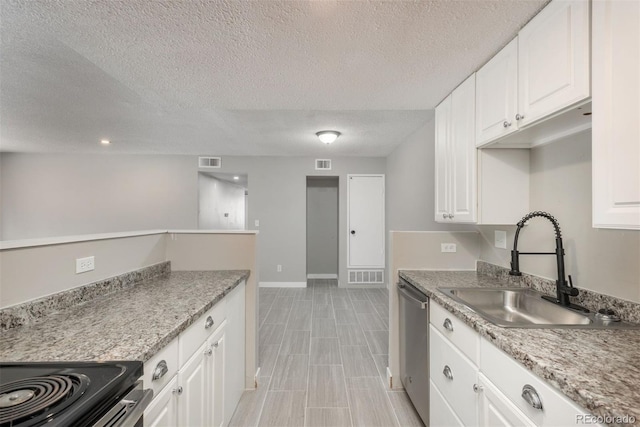 18071 E Kentucky Ave Unit 203, Aurora, CO 80017 - kitchen with a sink, stainless steel appliances, white cabinetry, a textured ceiling, and baseboards