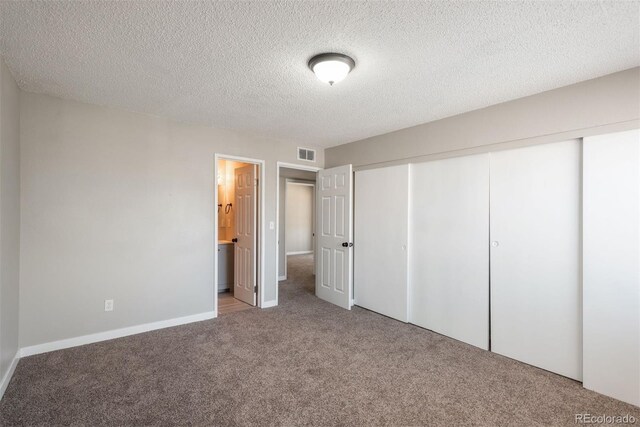 18071 E Kentucky Ave Unit 203, Aurora, CO 80017 - unfurnished bedroom with carpet, a closet, a textured ceiling, and baseboards