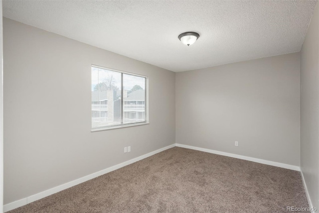 18071 E Kentucky Ave Unit 203, Aurora, CO 80017 - unfurnished room featuring carpet flooring, baseboards, and a textured ceiling
