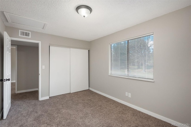 18071 E Kentucky Ave Unit 203, Aurora, CO 80017 - unfurnished bedroom with carpet, baseboards, a closet, and a textured ceiling