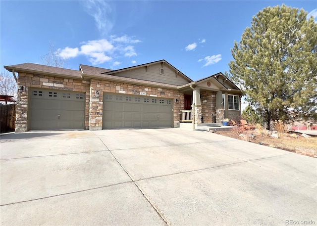 view of front of home featuring stone siding, concrete driveway, and an attached garage