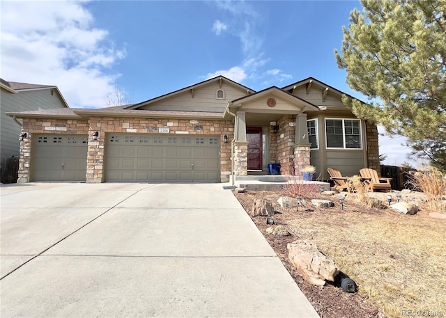 craftsman inspired home with stone siding, driveway, and an attached garage