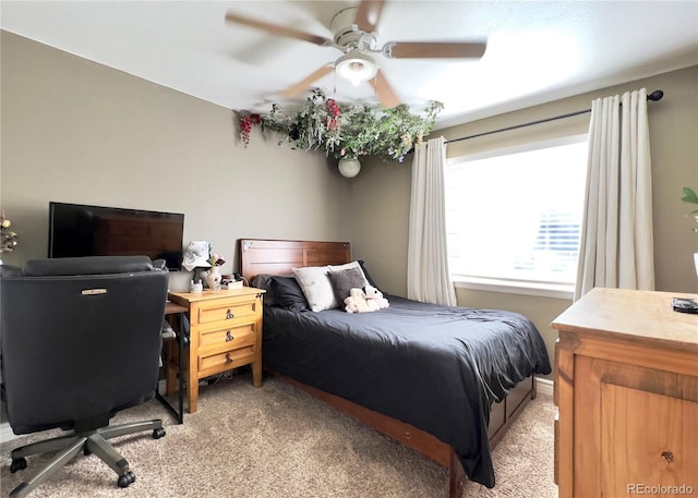 bedroom with light carpet and ceiling fan