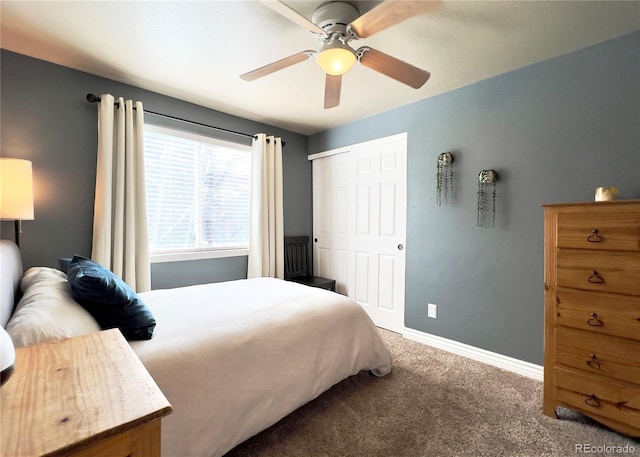 carpeted bedroom featuring a closet, ceiling fan, and baseboards