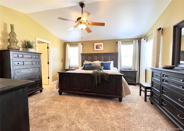 bedroom with baseboards, vaulted ceiling, a ceiling fan, and light colored carpet