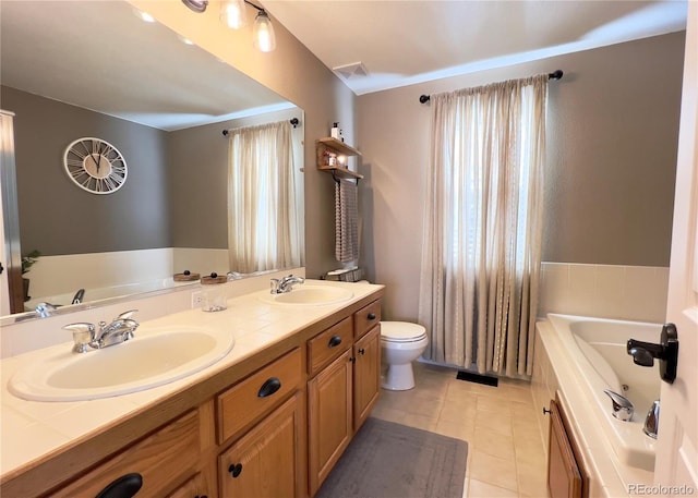 full bath featuring a tub, tile patterned flooring, visible vents, and a sink