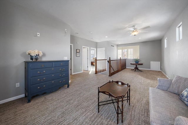 carpeted living room featuring ceiling fan