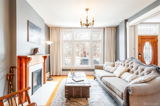 living room featuring a chandelier and light hardwood / wood-style flooring