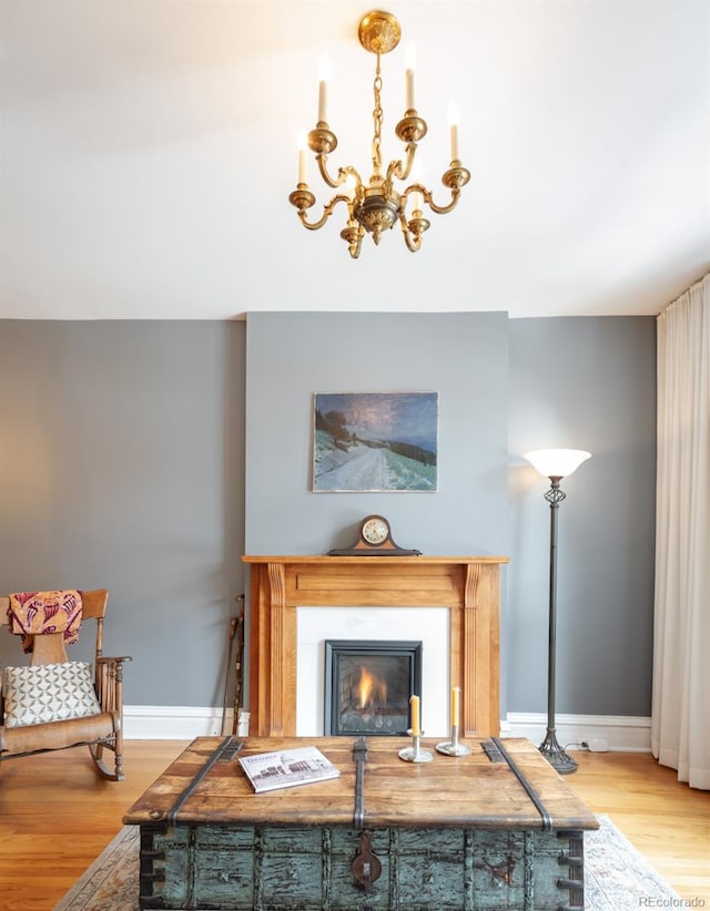 living room featuring an inviting chandelier and wood-type flooring