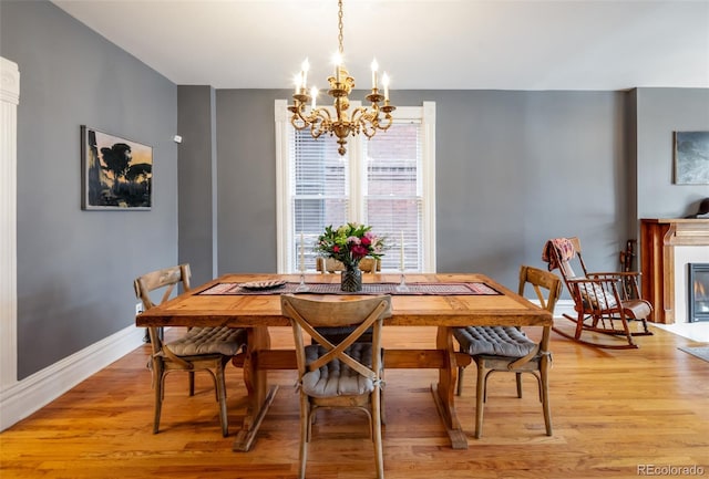 dining area featuring an inviting chandelier and light wood-type flooring