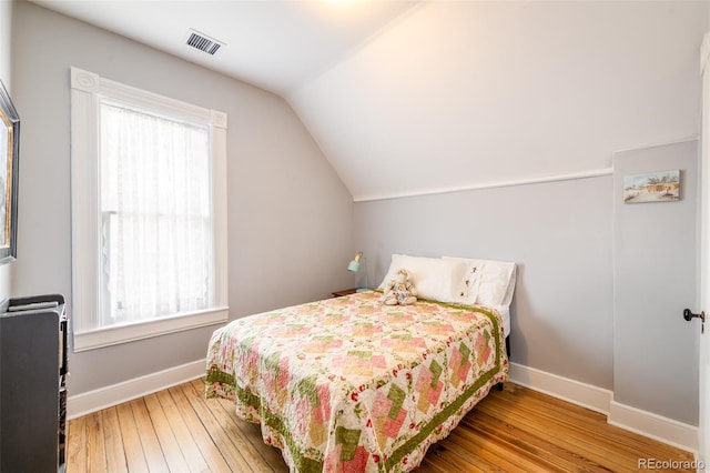 bedroom featuring lofted ceiling and wood-type flooring