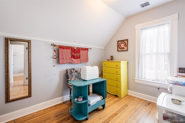 interior space with lofted ceiling and hardwood / wood-style flooring