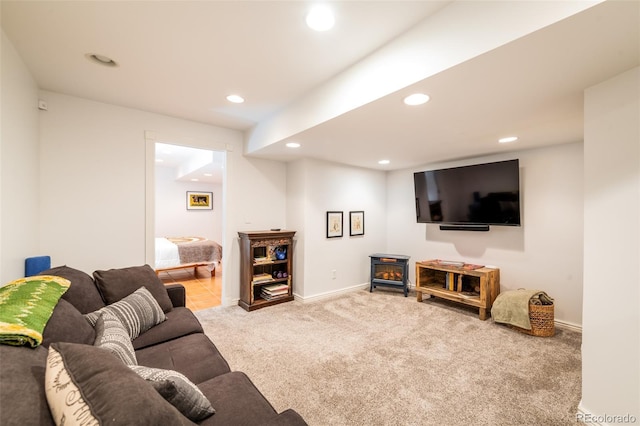 carpeted living room featuring a wood stove