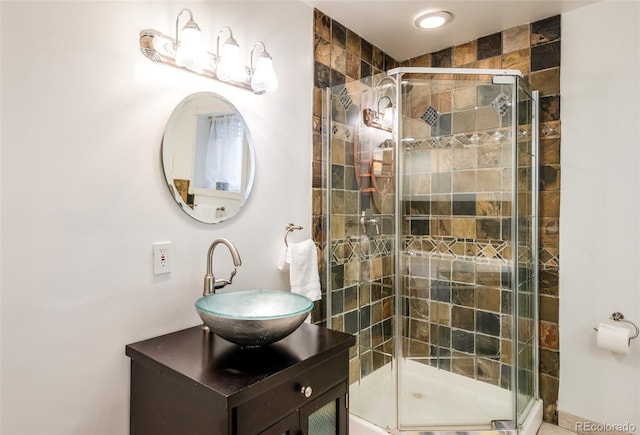 bathroom with vanity and a shower with shower door