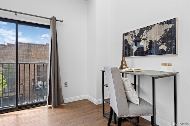 home office with baseboards, wood finished floors, and a healthy amount of sunlight