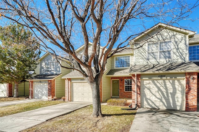 view of front of house featuring a garage, brick siding, driveway, and roof with shingles