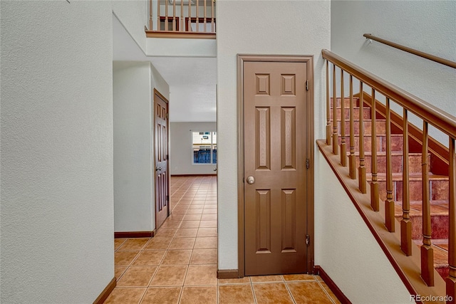 interior space with tile patterned flooring and baseboards