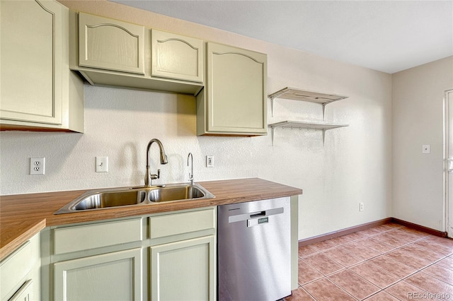 kitchen with light tile patterned flooring, a sink, butcher block countertops, dishwasher, and baseboards