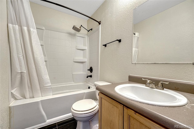 bathroom with toilet, shower / bathtub combination with curtain, vanity, and a textured wall