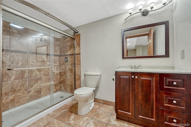 full bath featuring a textured ceiling, a textured wall, toilet, vanity, and a shower stall