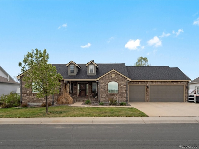5708 Wetland Loop, Frederick, CO 80504 - view of front facade with brick siding, driveway, a front yard, and a garage