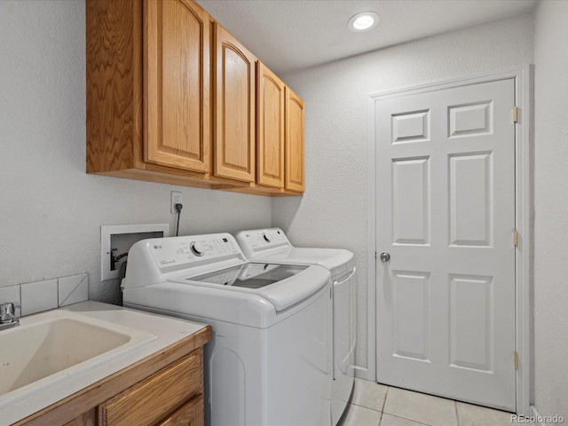 5708 Wetland Loop, Frederick, CO 80504 - laundry room featuring a sink, cabinet space, light tile patterned floors, and washing machine and dryer