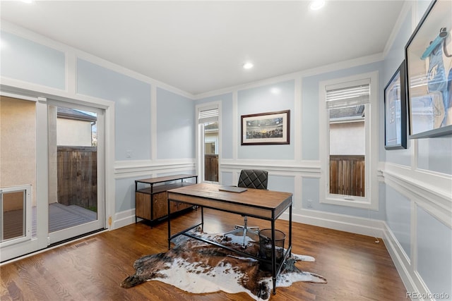 office space with dark wood-type flooring and ornamental molding