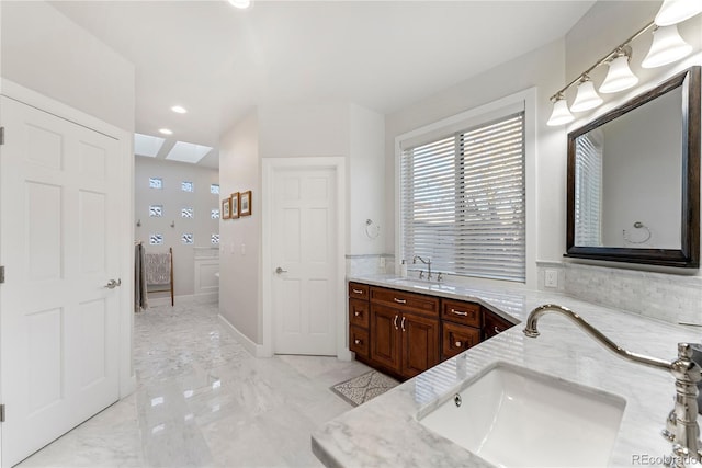 bathroom featuring vanity and a skylight