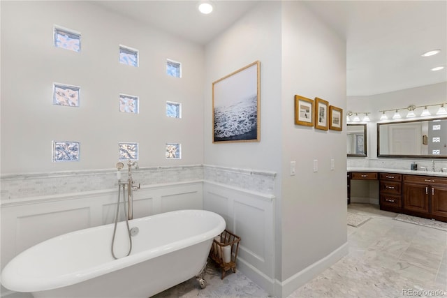 bathroom with a washtub and vanity