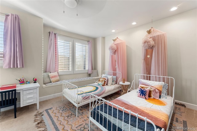 bedroom with light carpet and ceiling fan