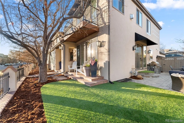 view of property exterior with a patio area and a yard