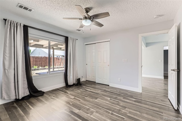 4932 Jasper St, Denver, CO 80239 - unfurnished bedroom featuring wood finished floors, a closet, a textured ceiling, and a ceiling fan